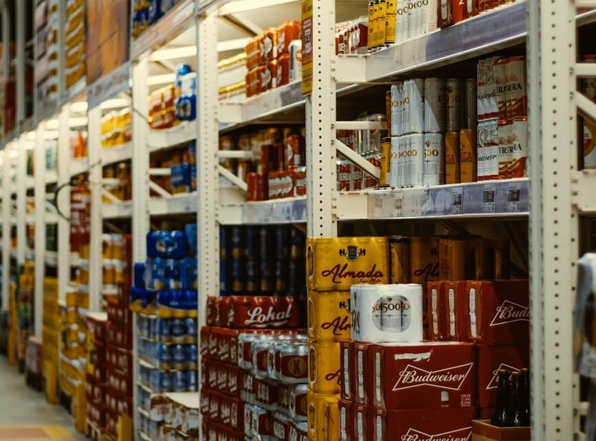 red and white labeled cans on shelf